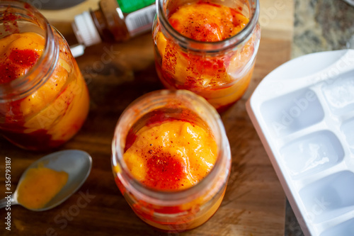 A top down view of jars filled with Mexican drink known as chamango, in a home kitchen setting.