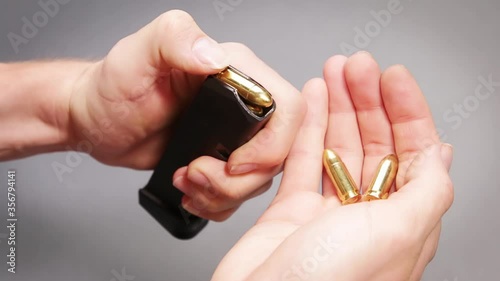 Hand emptying rounds from polymer pistol magazine into hand