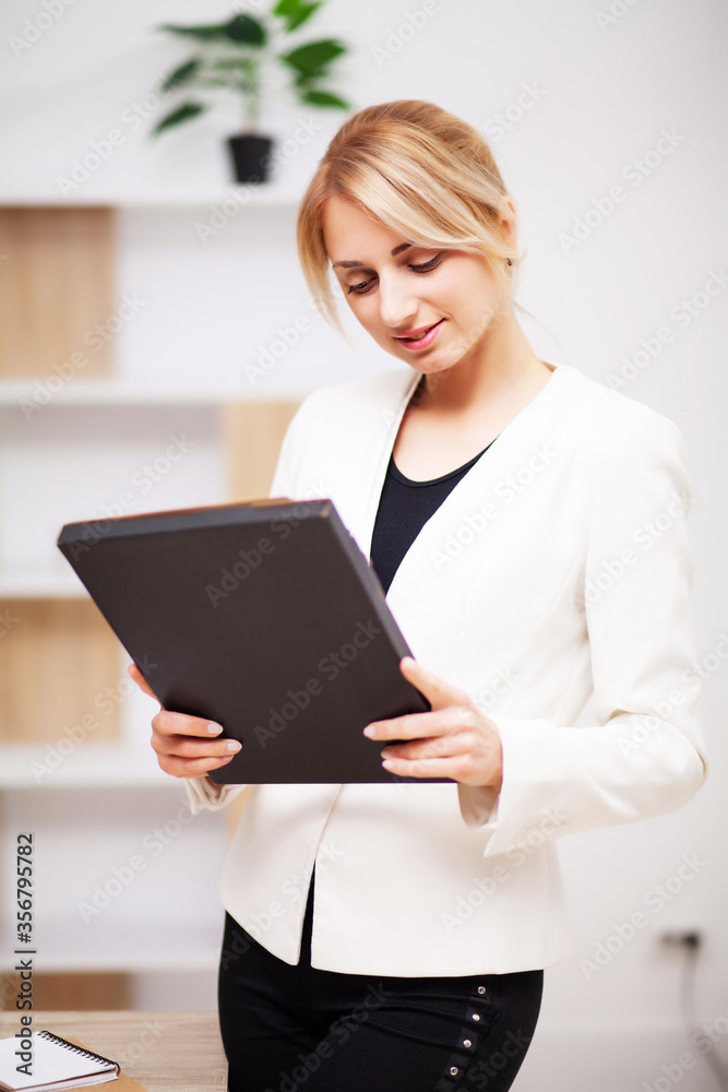 Young female businesswoman working in her office Young female businesswoman working in her office