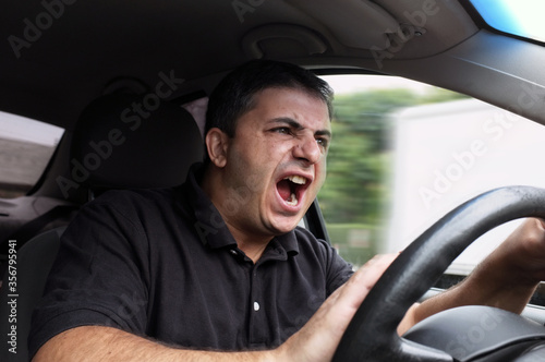 Angry man driver dangerously driving car without seat belts