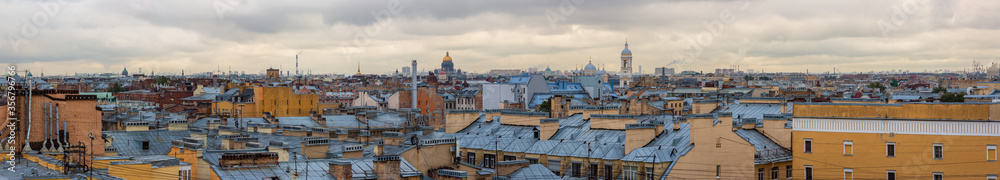 Great panorama with a top view of the historic city center of St. Petersburg. Cityscape with roofs of buildings and domes of cathedrals. Landmarks of Saint-Petersburg, Russia.