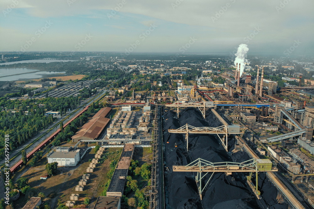 Aerial view of huge Metallurgical Plant, smokestacks and chimneys with smoke. Environmental pollution from petrochemical production industrial factory.