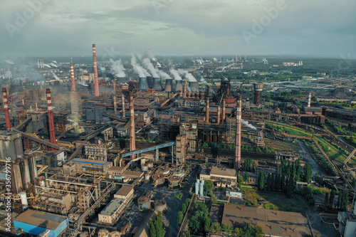 Aerial view of huge Metallurgical Plant  smokestacks and chimneys with smoke. Environmental pollution from petrochemical production industrial factory.