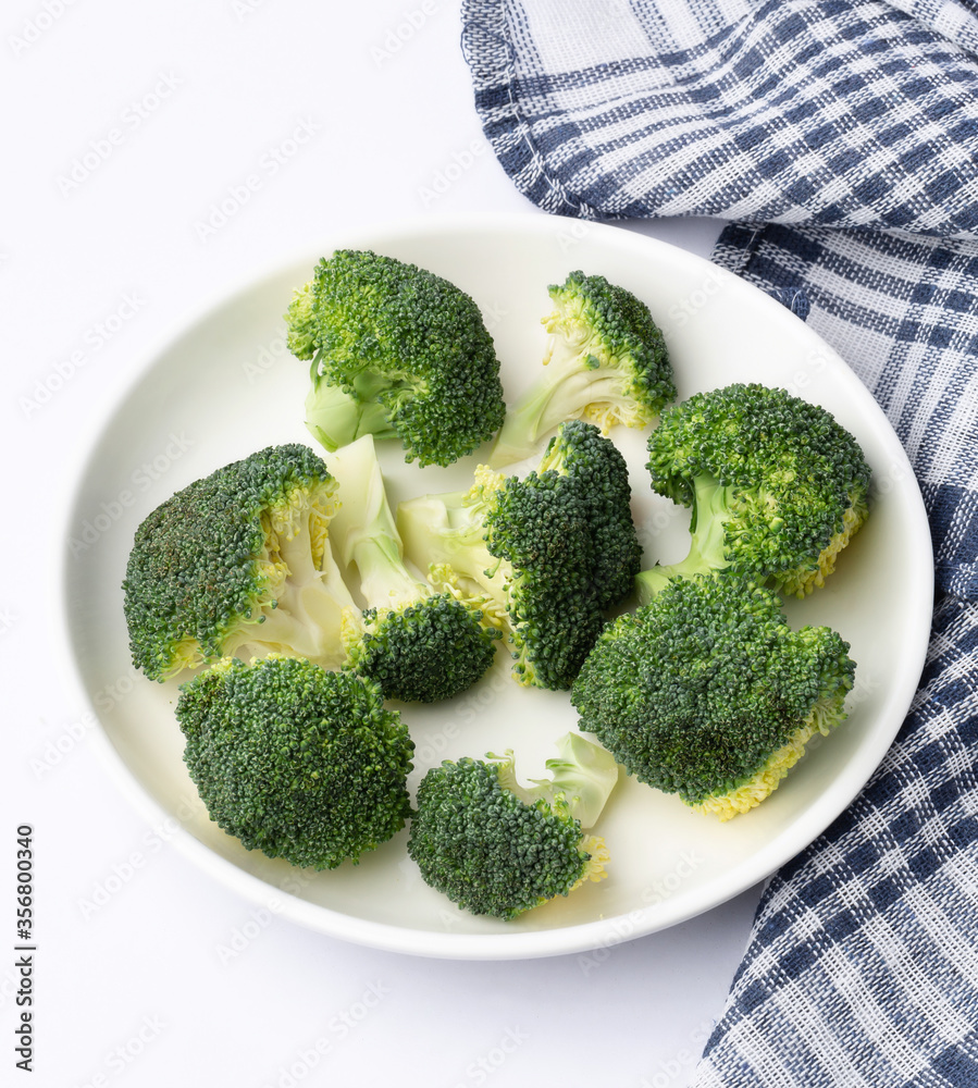 fresh broccoli in a dish on white background fresh broccoli in a dish on white background