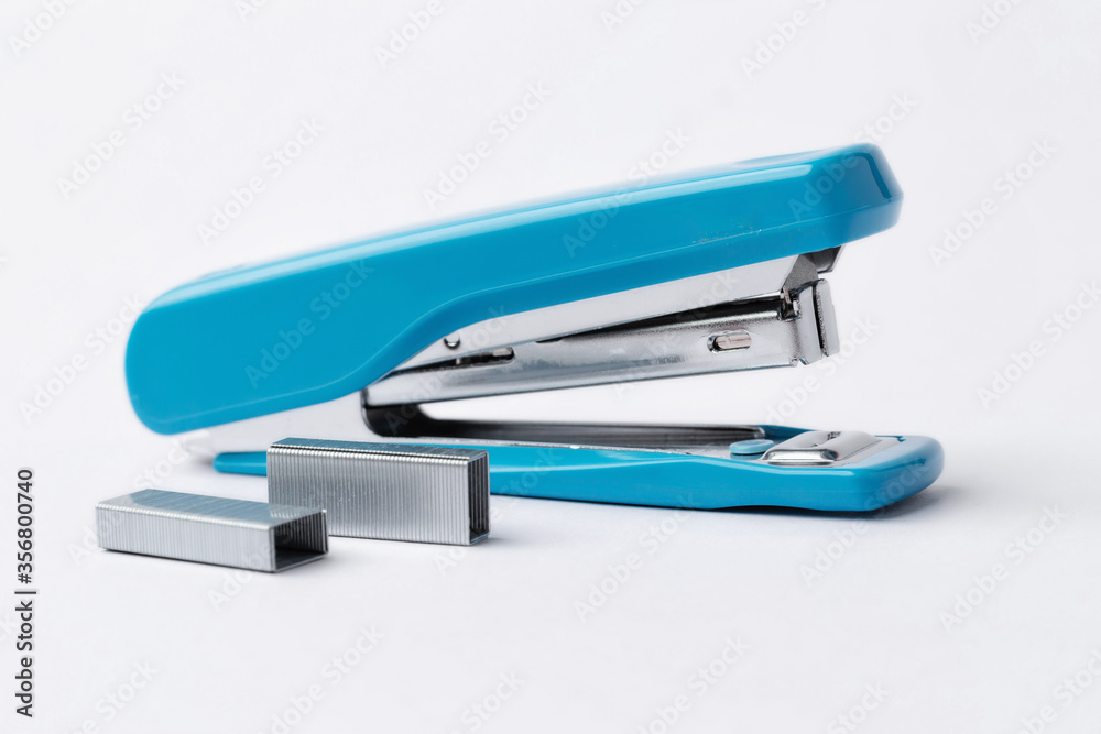 Blue stapler on a white background. Blue stapler on a white background.