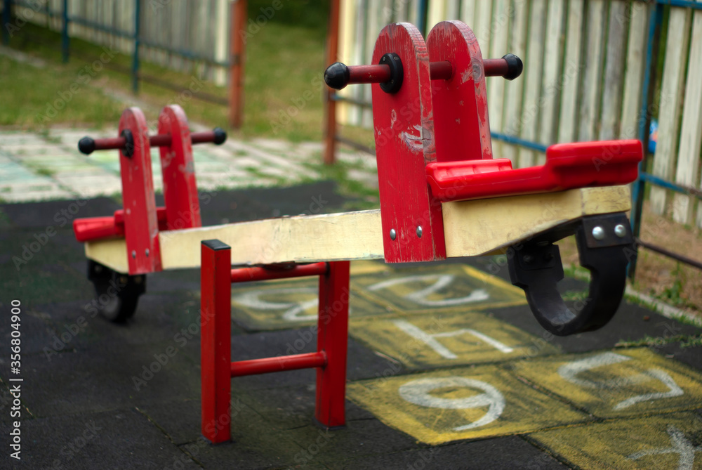 red wooden swing