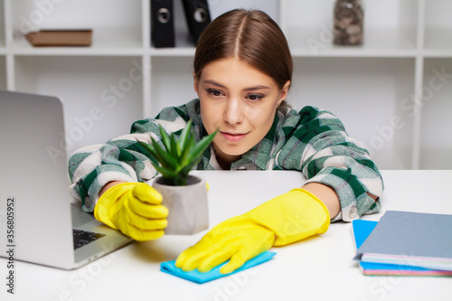 An employee of the cleaning company fulfills orders for office cleaning