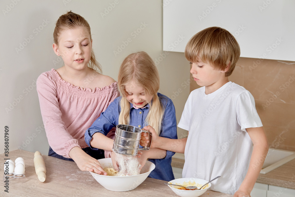 Cute beautiful children with blond hair are preparing pizza dough. Cute beautiful children with blond hair are preparing pizza dough.