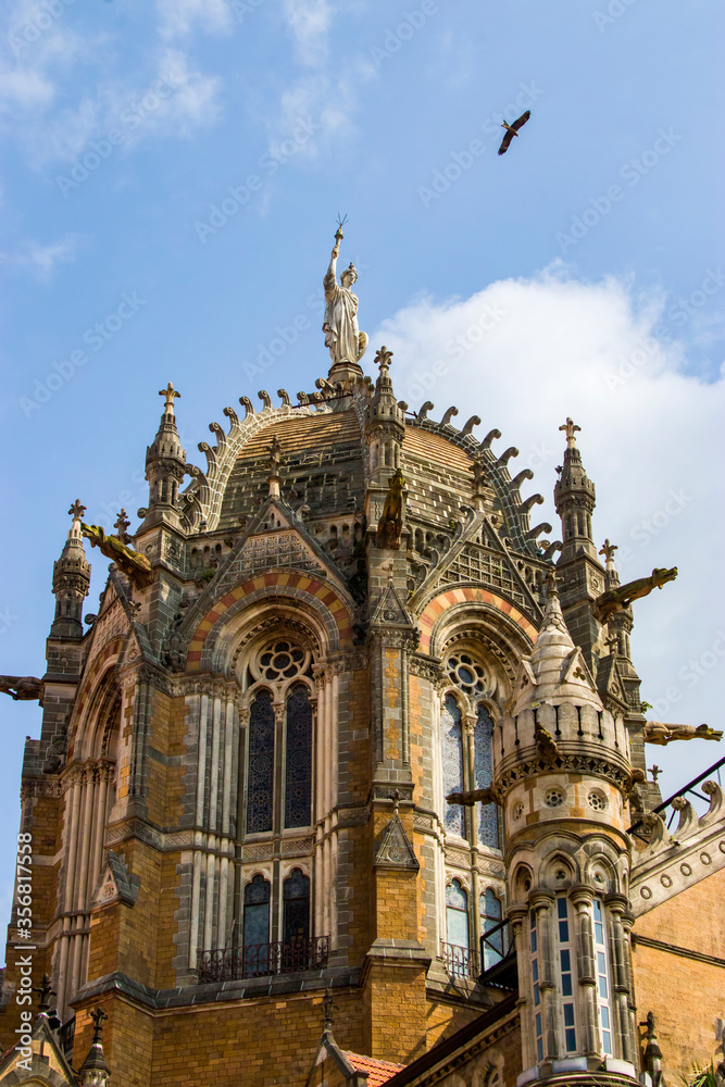 Fototapeta premium Mumbai India Nov 9th 2019: The symbol of Progress statue on the top of dome of train station 