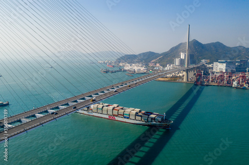 Top view of cargo ship pass though suspension bridge photo