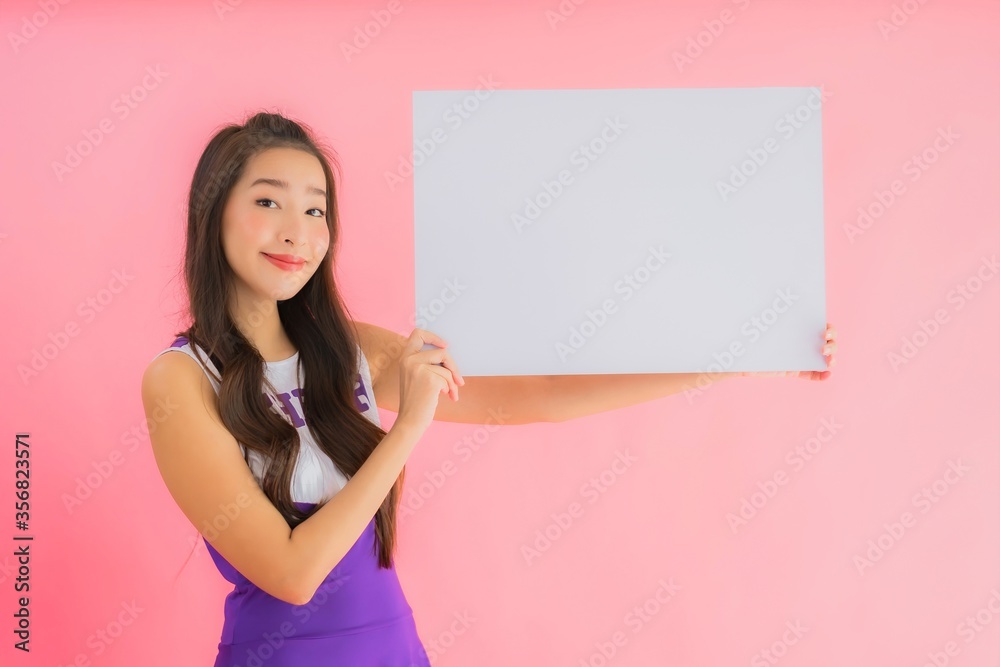 Portrait beautiful young asian woman cheerleader smile show empty white board Portrait beautiful young asian woman cheerleader smile show empty white board