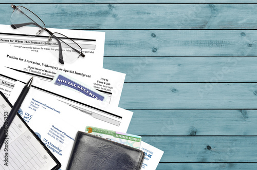 USCIS form I-360 Petition for amerasian, widower or special immigrant lies on flat lay office table and ready to fill. U.S. Citizenship and Immigration services paperwork concept