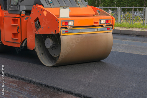 Urban road construction, paver. Road roller for laying new asphalt.
