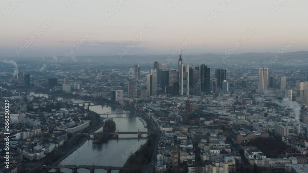 Panoramic view of Downtown Frankfurt am Main Skyline financial business banking district in the morning at dusk from high above. Slow push in Aerial Drone Shot