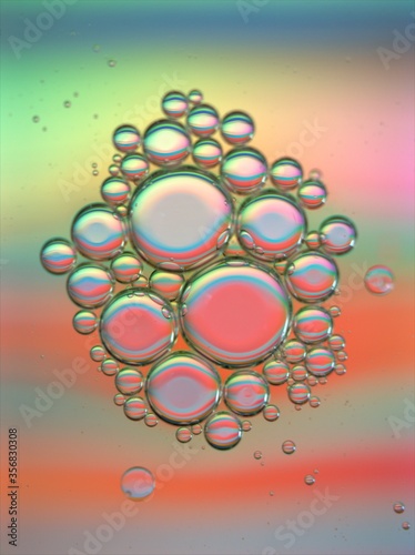 Beautiful bubbles oil with colorful orange shiny background  dropslets macro image  abstract background  sweet pastel color for card design