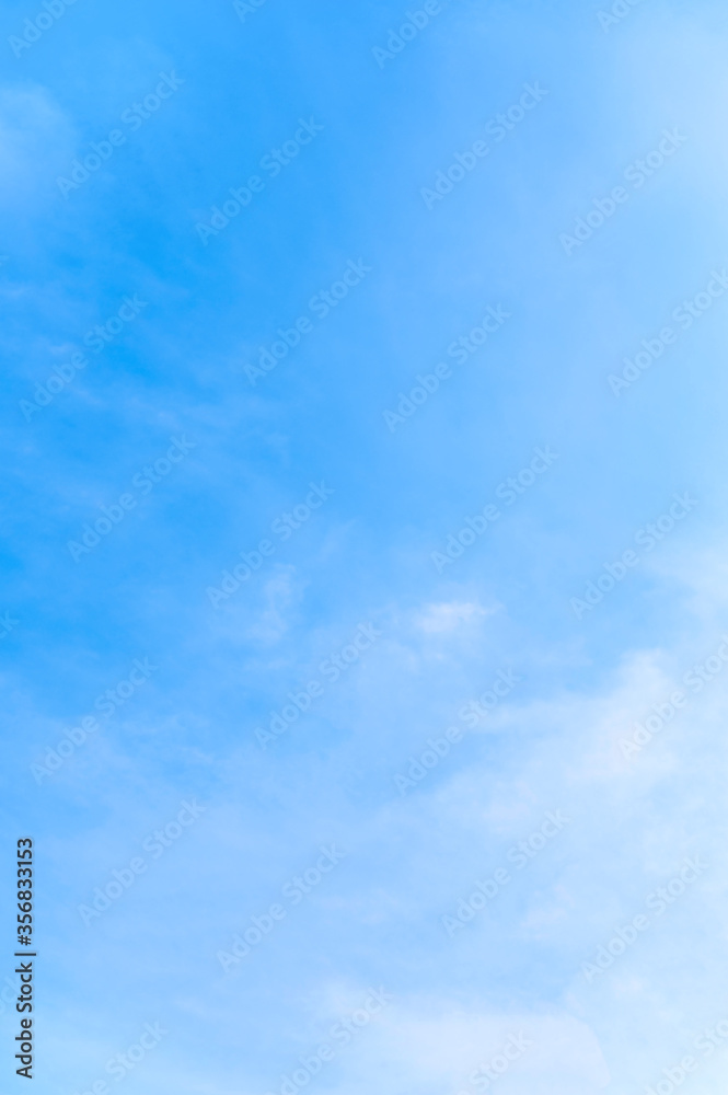 Vertical of tranquil blue sky with smooth cloud