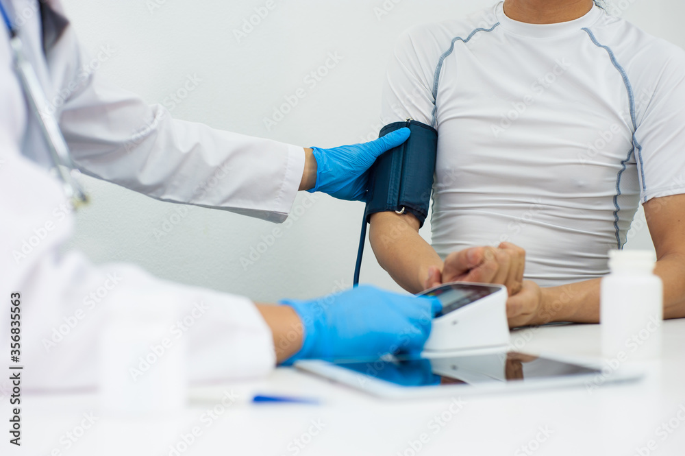 The doctor uses a sphygmomanometer To check the blood pressure of patient. The doctor uses a sphygmomanometer To check the blood pressure of patient.