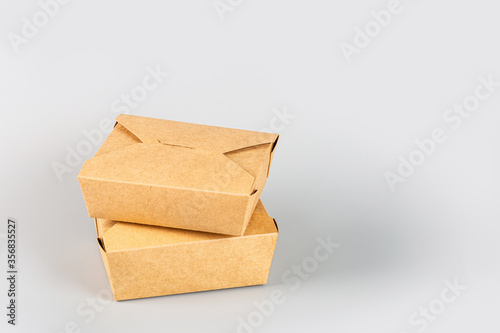 craft paper containers for food on gray background. Food delivery service. Takeaway food during coronavirus covid-19 pandemic isolation, Empty cardboard Paper package. Long web banner with copy space