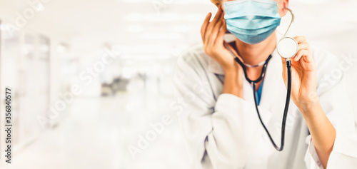 Doctor wear face mask in hospital protect from coronavirus disease or COVID-19. Medical staff are high risk people to receive infection from coronavirus disease or COVID-19. photo