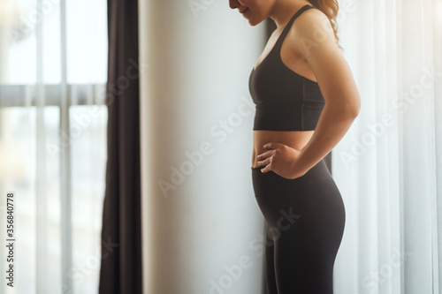 Closeup image of a fitness woman  preparing for workout at home