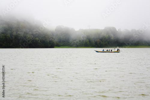 Boat sailing in Situ Patenggang Lake. Situ Patenggang or Patenggang Lake is a natural lake located in the tourist area of Ciwidey, South Bandung West Java, Indonesia.