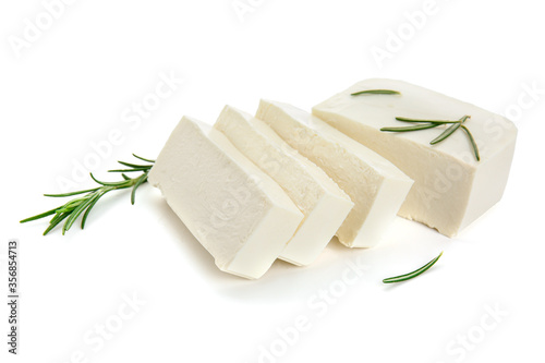 Tasty feta cheese with herbs on white background photo
