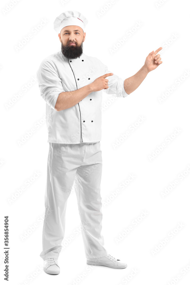 Handsome male chef pointing at something on white background Handsome male chef pointing at something on white background