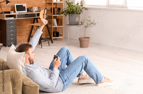 Lazy man with mobile phone ...