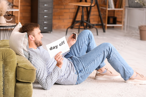 Lazy man with mobile phone ...
