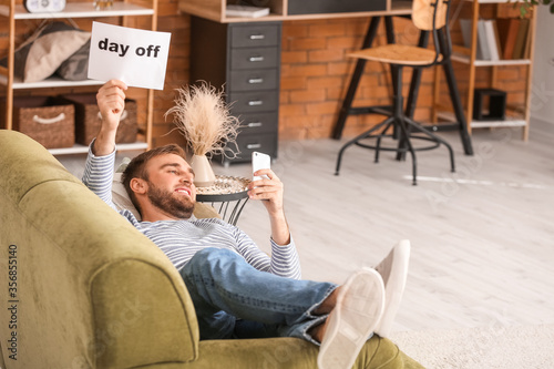 Lazy man with mobile phone ...