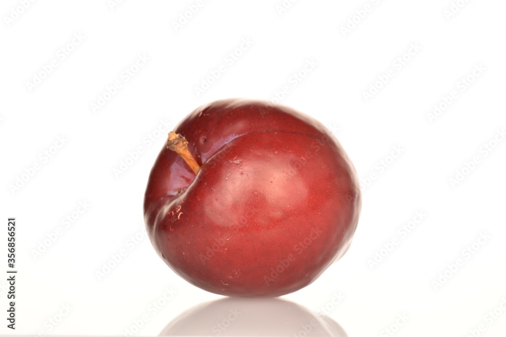 Ripe juicy, organic red plum, close-up, on a white background.
