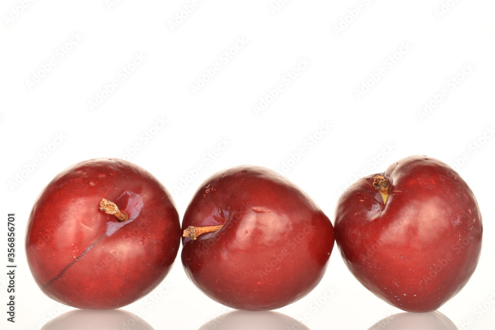 Ripe juicy, organic red plum, close-up, on a white background.