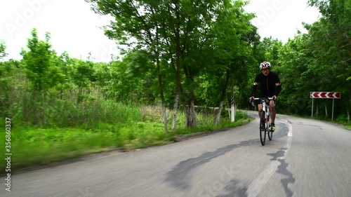Wallpaper Mural professional sportsman cycling road bike, sport concept, mountain road at sunset Torontodigital.ca