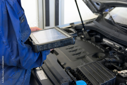 Electrical diagnostics of a car. A mechanic diagnoses a car in a car service.	