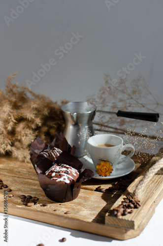 chocolate muffins on the table with a cup of coffee