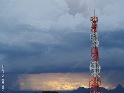 Mobile phone transmitter antenna with dramatic sky with cloud.
