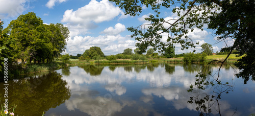 Lake with reflections and blue sky and clouds 