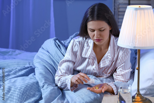 Young woman taking sleeping...