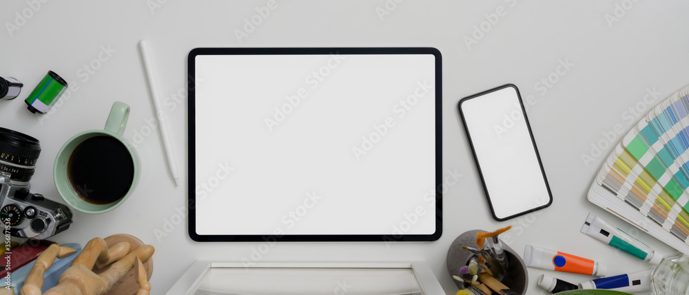 Minimal worktable with mock-up tablet, smartphone, painting tools and coffee mug - obrazy, fototapety, plakaty 