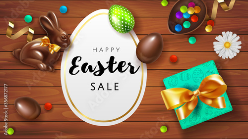 Happy easter sale offer banner template. Chocolate 3d realistic eggs with lettering isolated on wooden background. Easter eggs and chocolate bunny top view with gift. Spring Shop market poster design