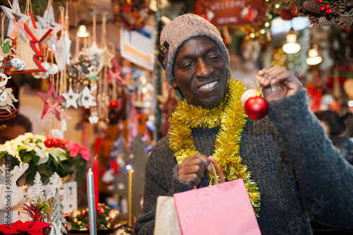 Guy choosing Christmas decorations