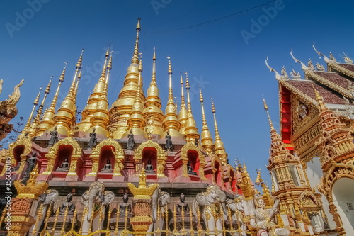 view of many golden pagodas Mandalay style with blue sky background  Wat Phra That Suthon Mongkhon Khiri  Denchai District  Phrae Province  northern of Thailand.