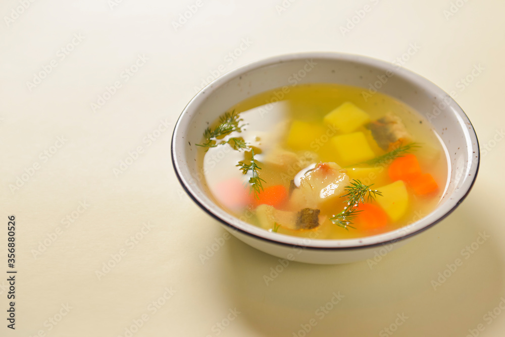 Delicious stew soup with meat and vegetables served in a white bowl over bright pastel yellow background. Healthy diet. Delicious stew soup with meat and vegetables served in a white bowl over bright pastel yellow background. Healthy diet.