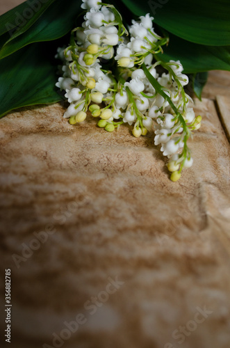 bouquet of lilies of the valley on a table with craft paper