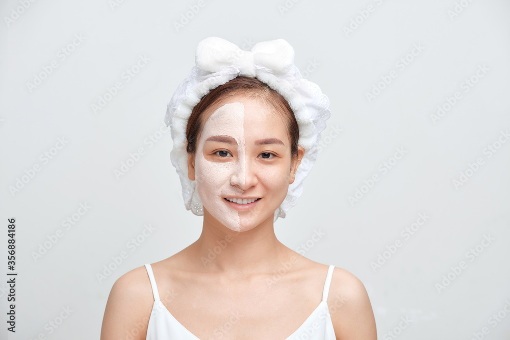 Portrait of young Asian woman applying facial clay mask Portrait of young Asian woman applying facial clay mask