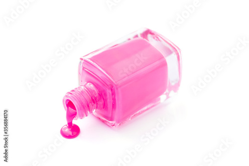 Bright pink nail polish in a bottle isolated on white.