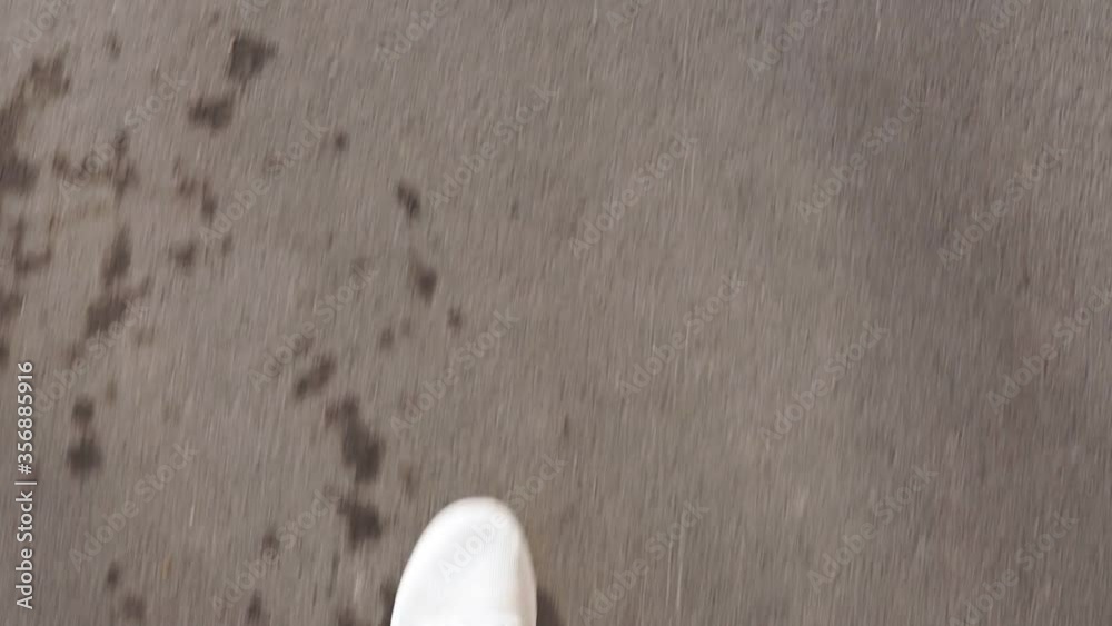 man in white sneakers walks down the street on a bright Sunny day. pov video, first person man in white sneakers walks down the street on a bright Sunny day. pov video, first person