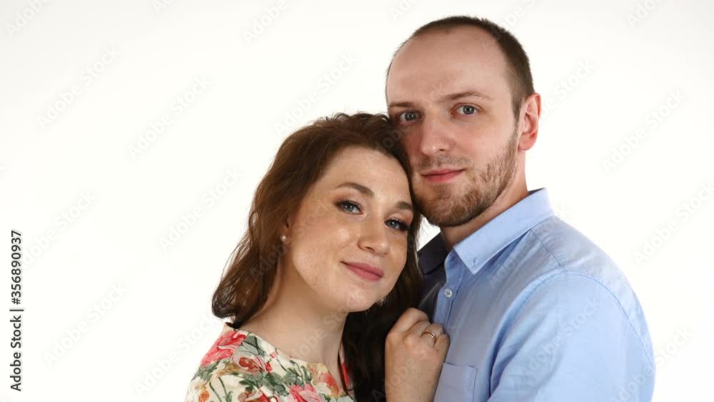 Happy couple embracing and looking camera on white background Happy couple embracing and looking camera on white background
