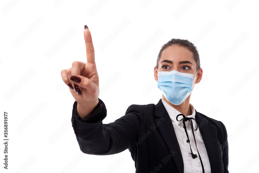 Young businesswoman in face mask pointing to copyspace Young businesswoman in face mask pointing to copyspace