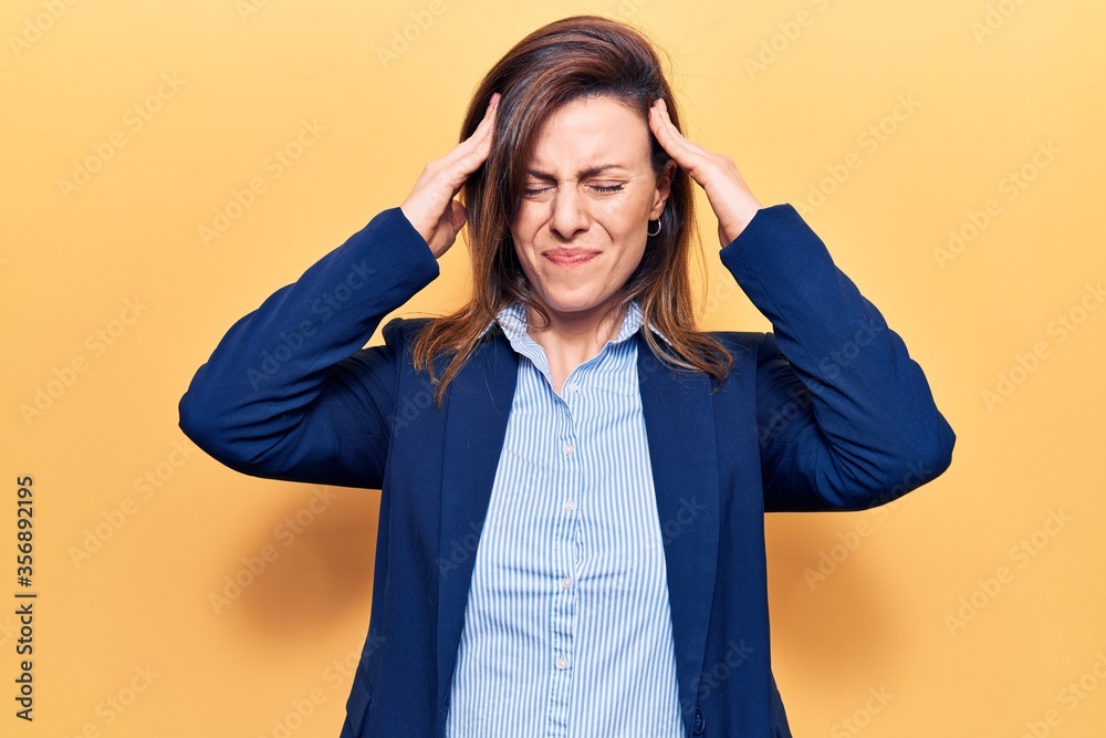 Young beautiful woman wearing business clothes with hand on head, headache because stress. suffering migraine. Young beautiful woman wearing business clothes with hand on head, headache because stress. suffering migraine.